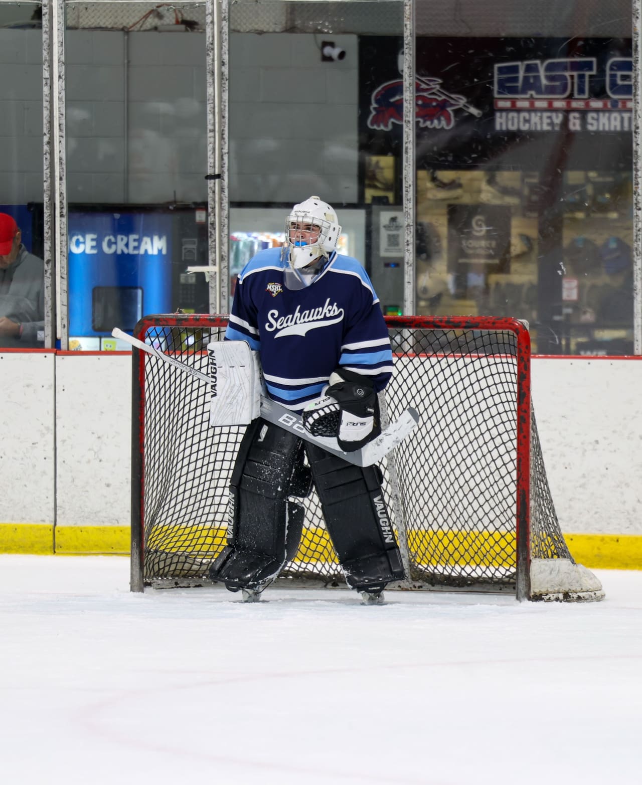 A South River goaltender standing square in the crease in a navy and ice-blue Seahawks jersey